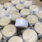 Round tin containers packed in individual protective bags