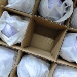 Tin boxes packed with protective paper wrapping and carton dividers