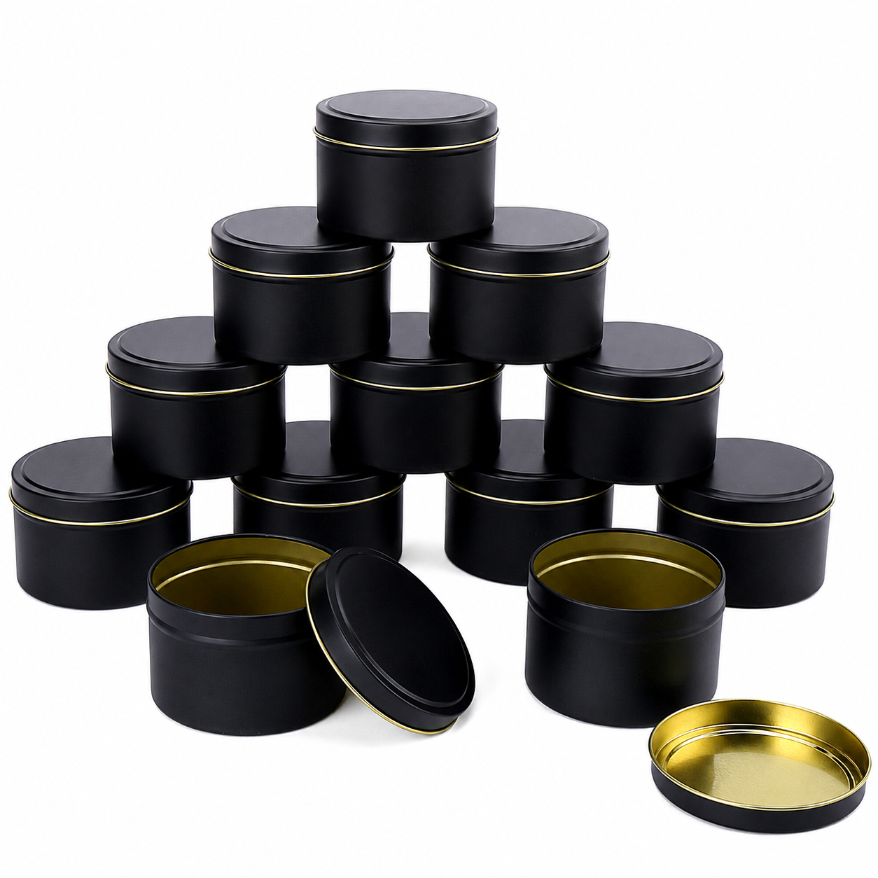 Black 4 oz candle tins with raised lids and gold-colored interiors