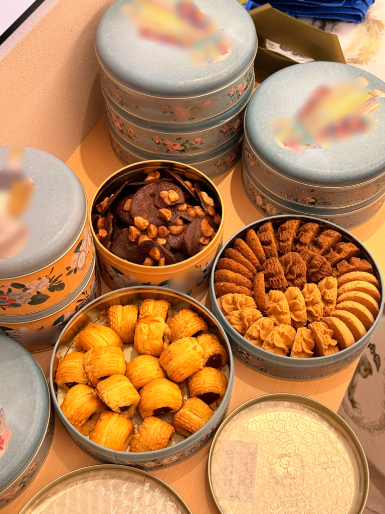 Round custom cookie tins filled with assorted cookies and biscuits